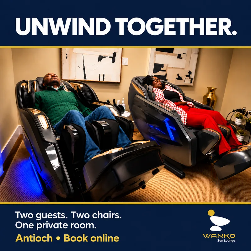 Two guests relaxing side by side in massage chairs in the private lounge